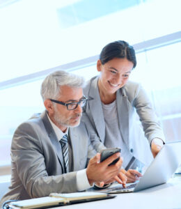 professionals looking at a laptop