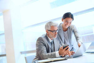 professionals looking at a laptop