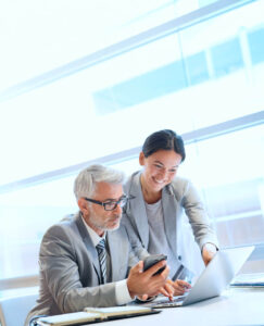 professionals looking at a laptop