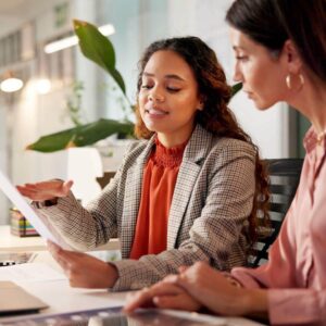two people looking at paper documents